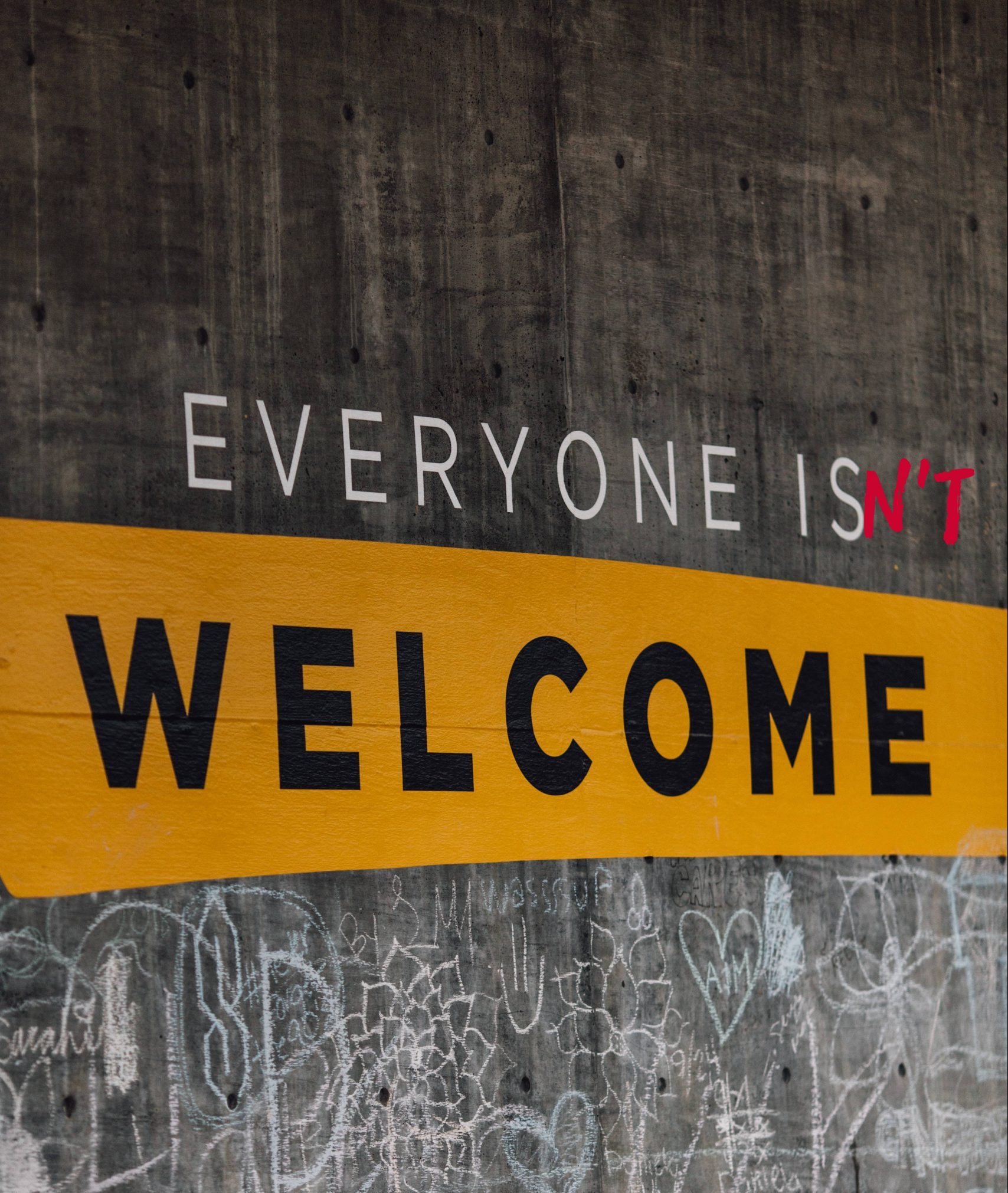 Writing on a wall reads 'everyone isn't welcome'
