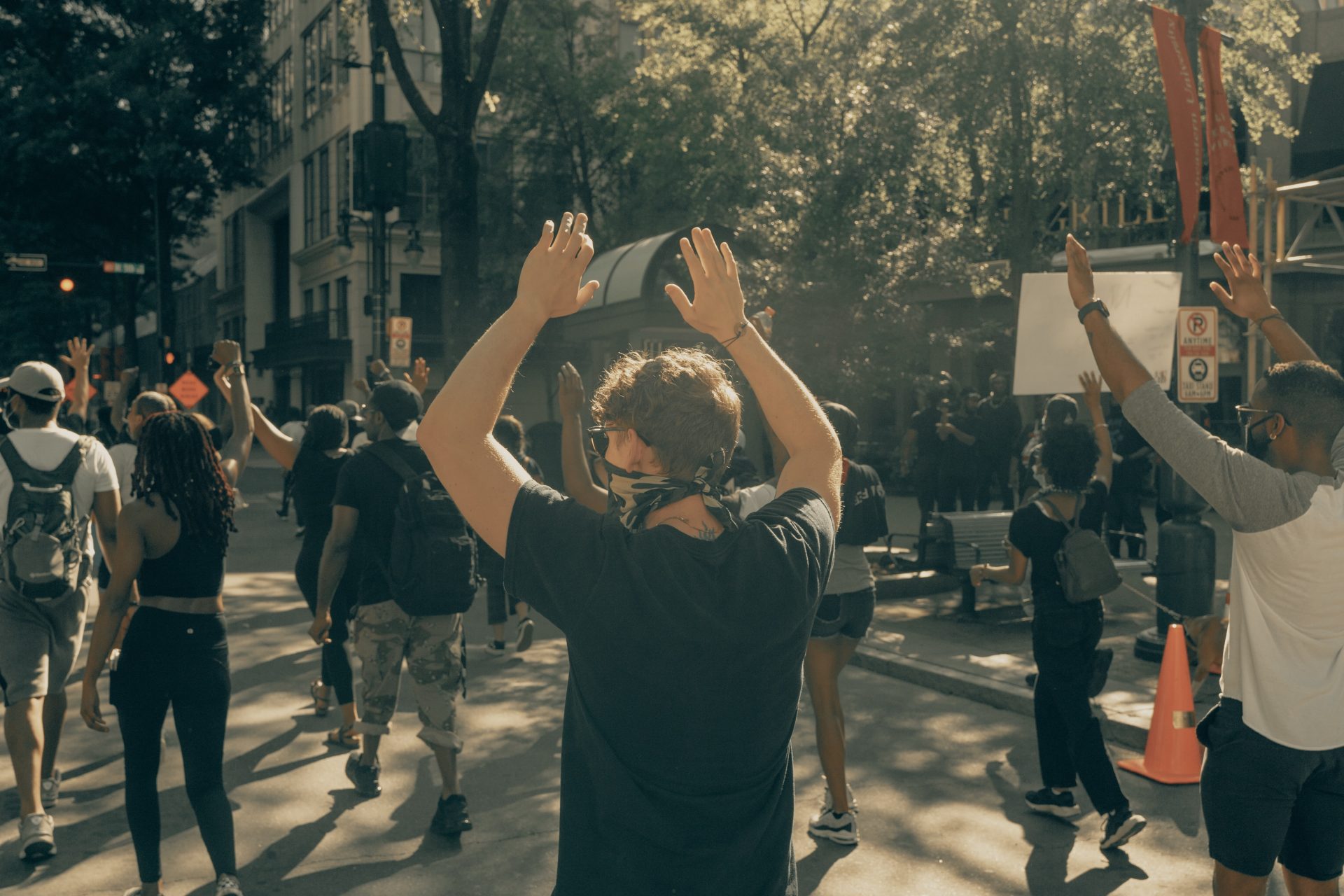 Photo of protesters with hands raised