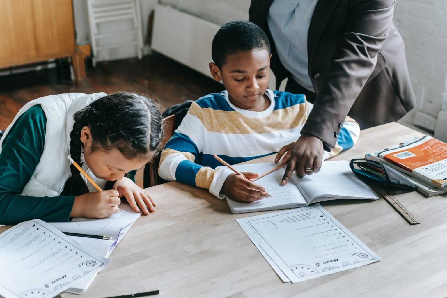 Children sit at a desk