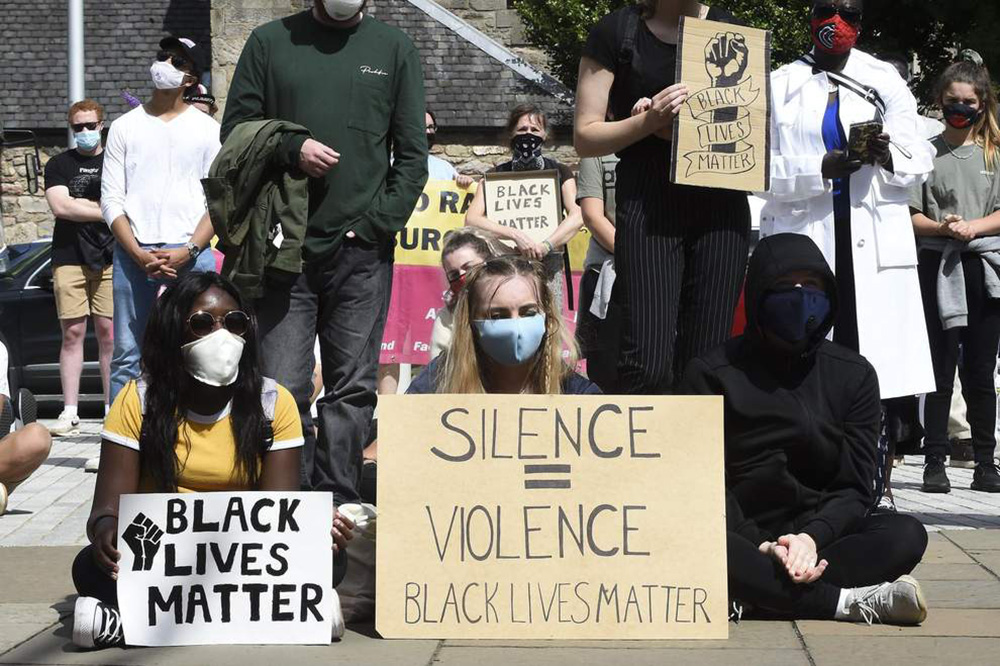 Signs reading  'Black Lives Matter' 'Silence = Violence, Black Lives Matter'
