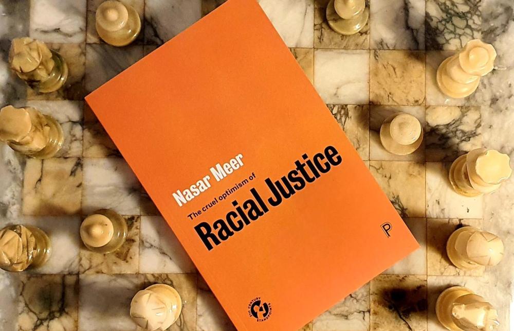 An orange book. Nasar Meer: The cure optimism of Racial Justice