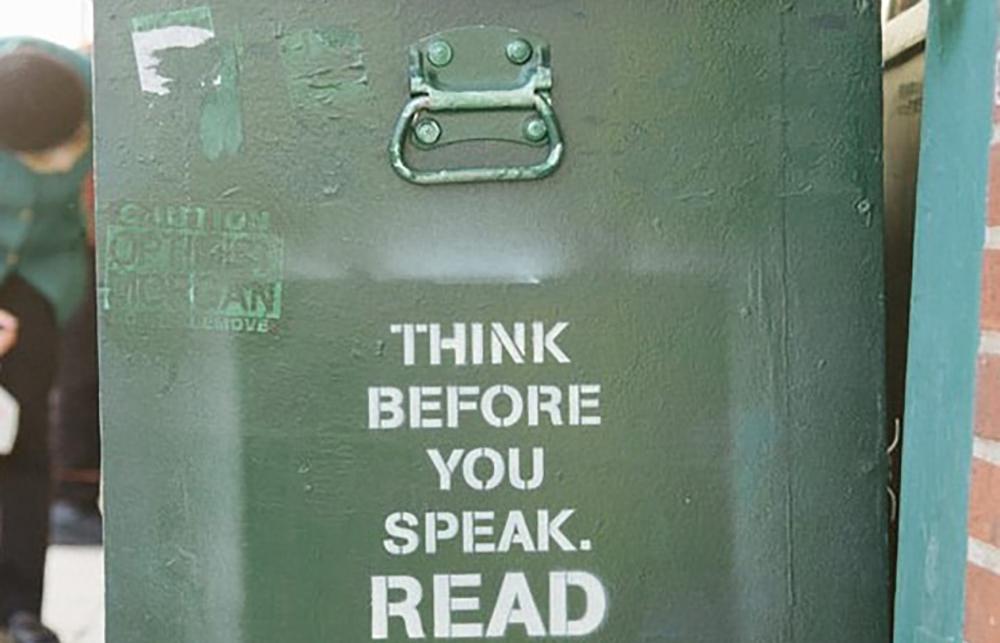 Graffiti that reads 'think before you speak. read before you think.'